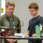 DTRA-AF Col. Lane reviewing the design and operation of an Air Challenge team's drone at the SE VA Challenge (photo credit DTRA)